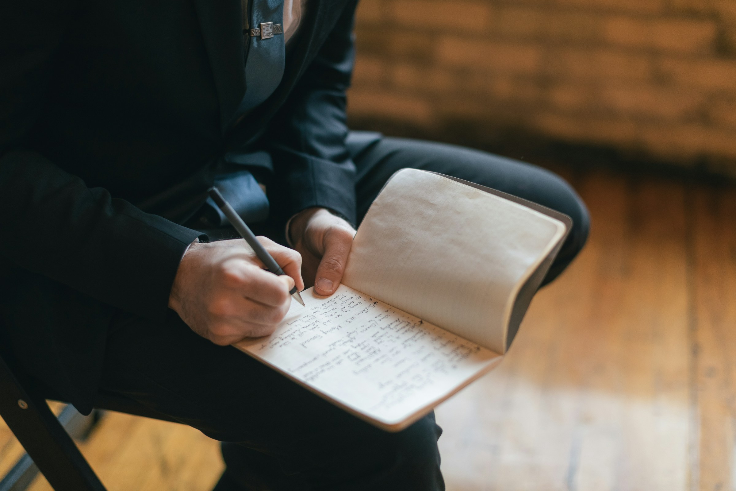 An author writing in a notebook