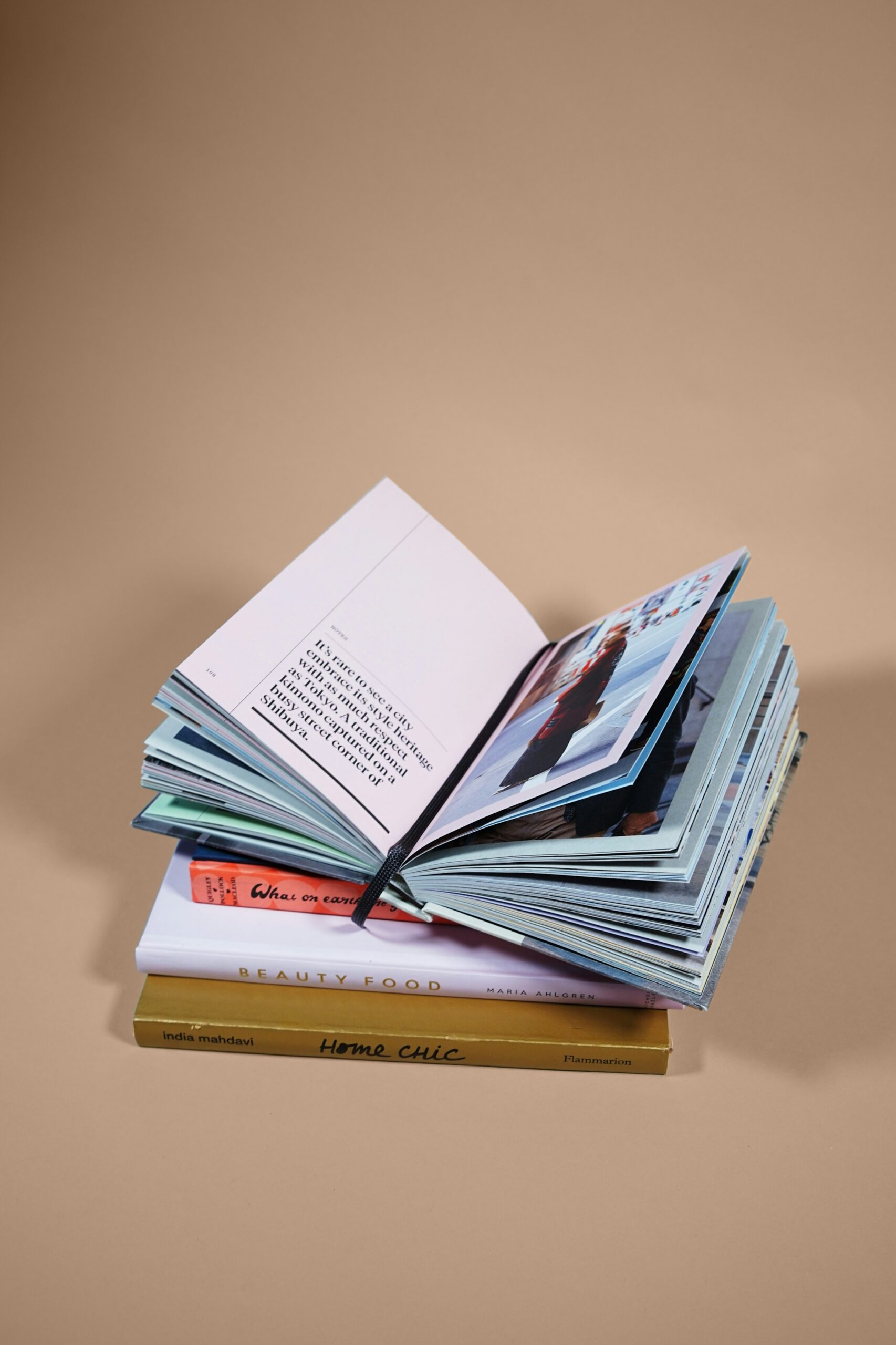 An open illustrated book resting on a stack of books